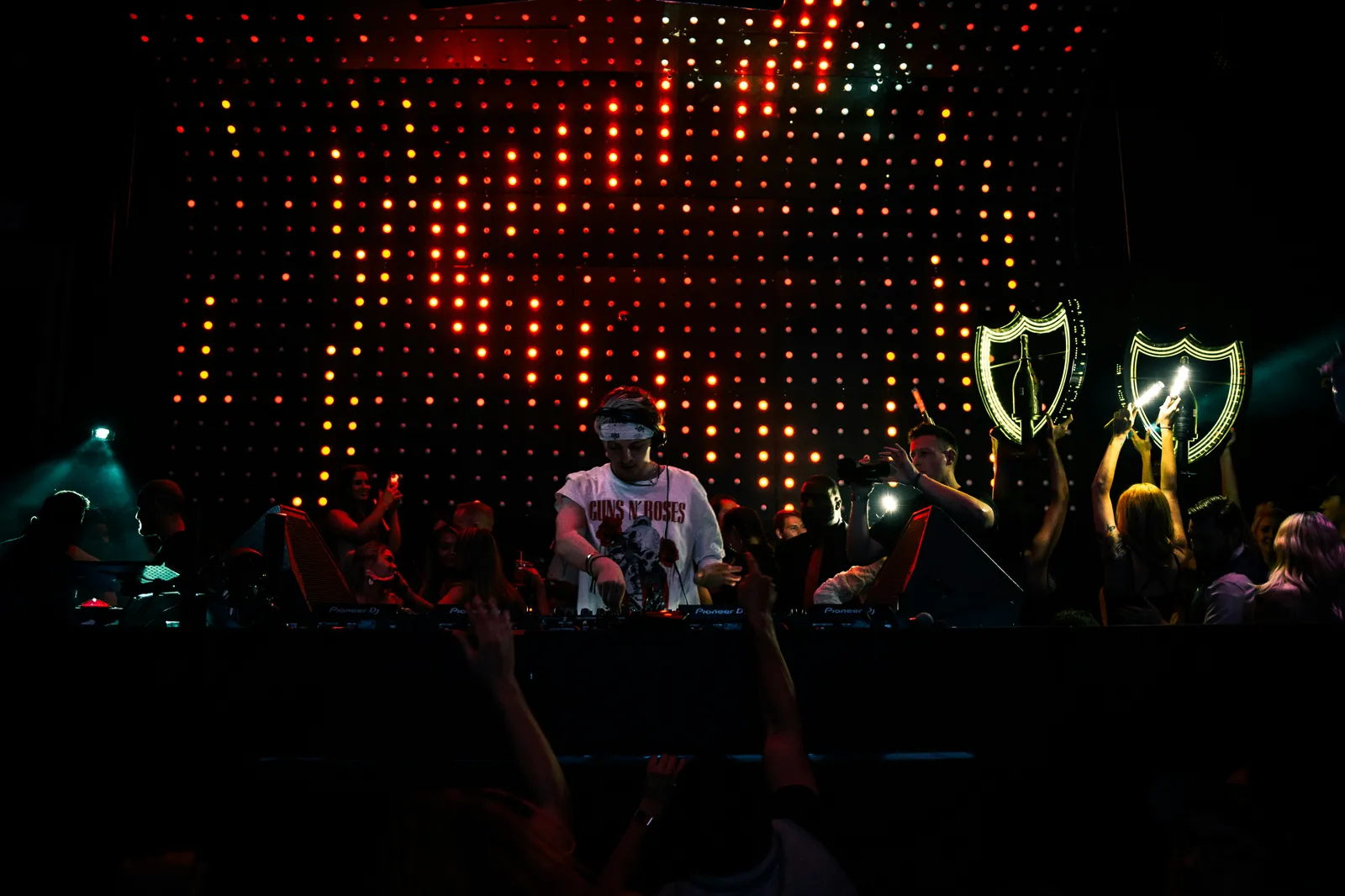 man in white shirt standing on stage